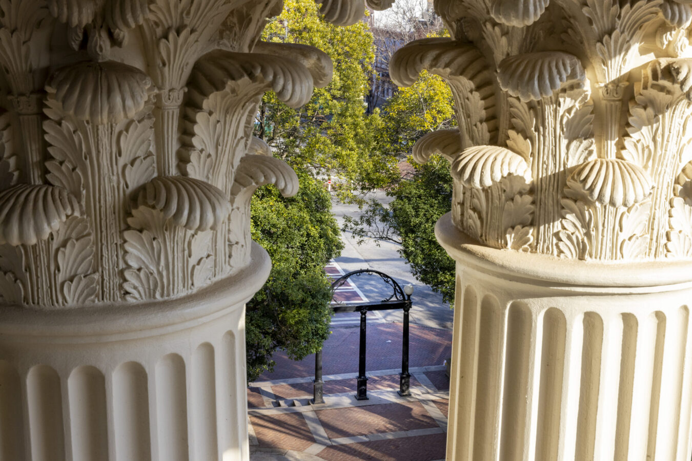 Architectural detail of the top of columns at the Holmes-Hunter building with the arch in the background.