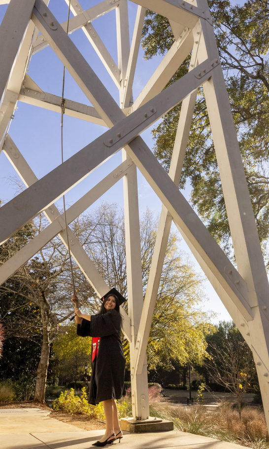 A graduate rings the Chapel bell.